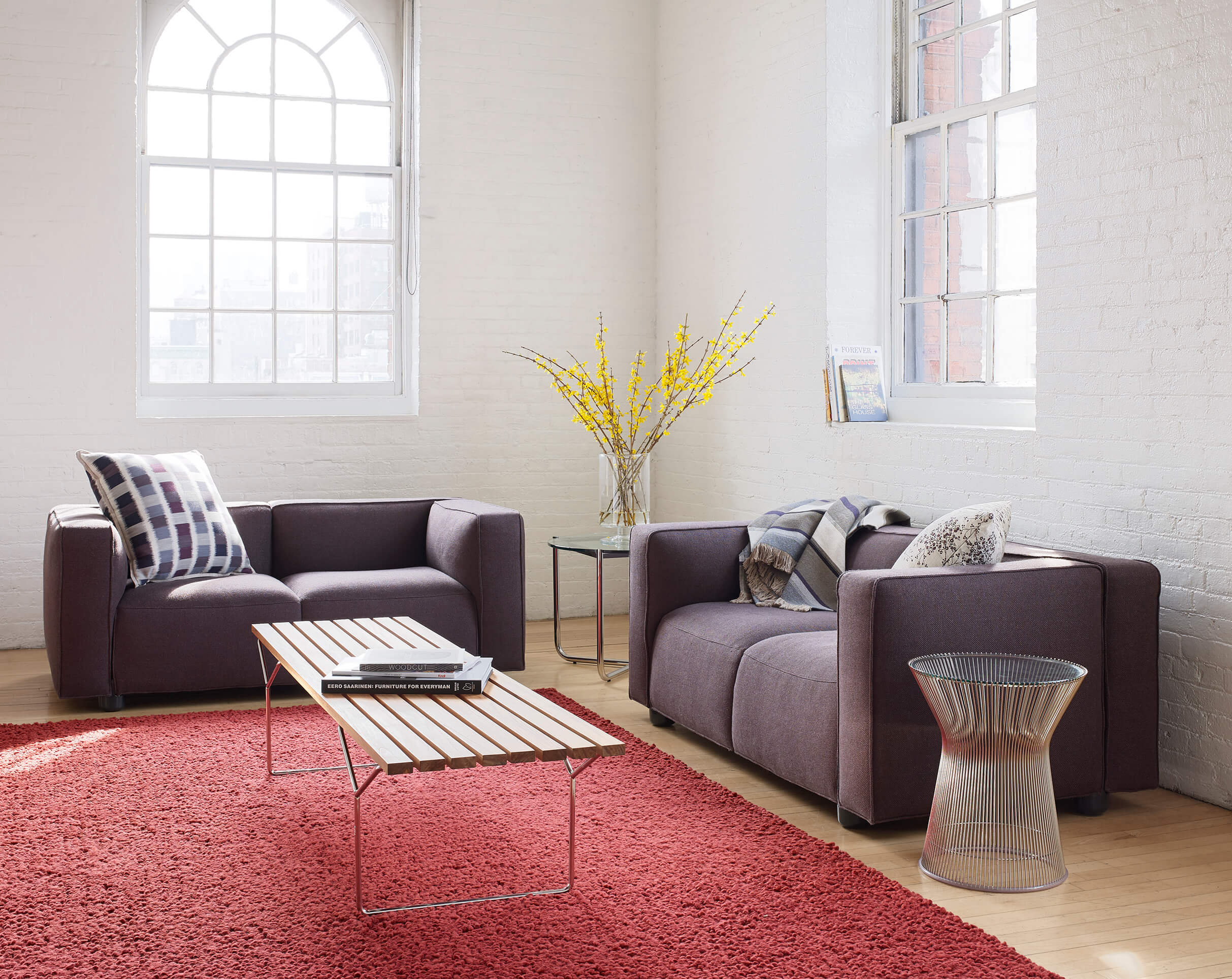 Platner stool in a living room with sofas