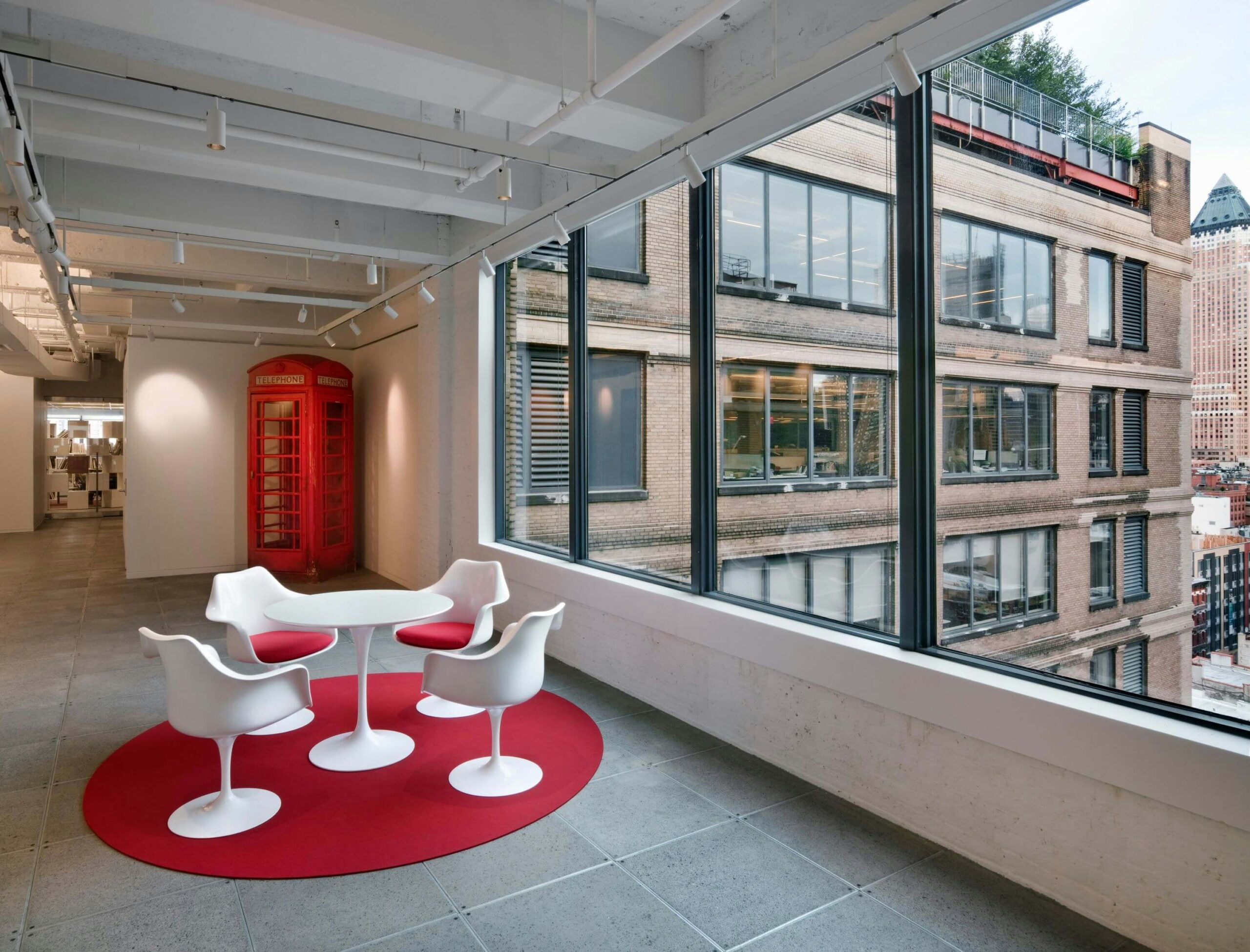 Tulip Arm Chairin a modern office next to a large window