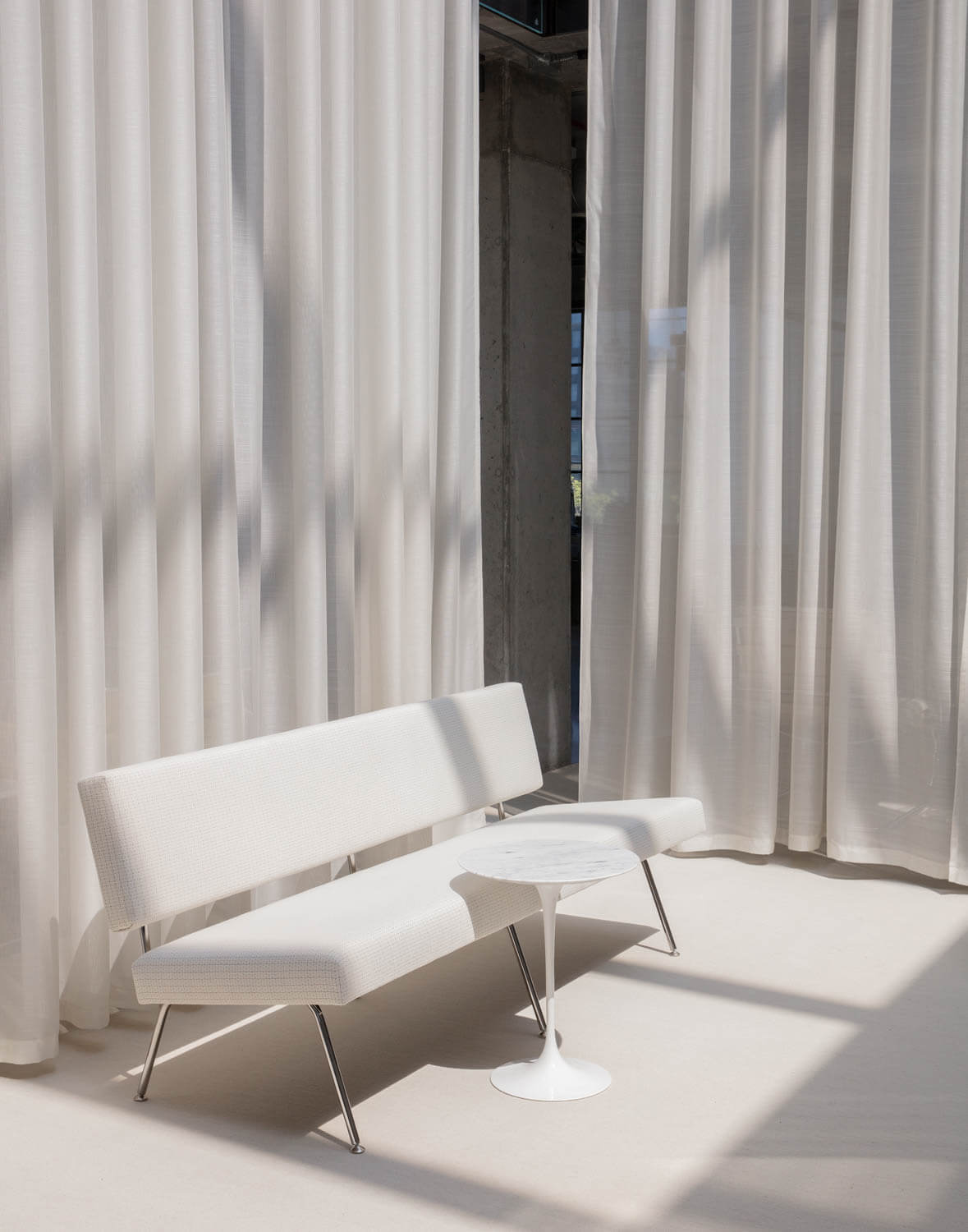 Florence Knoll Model 33 white sofa with a side table