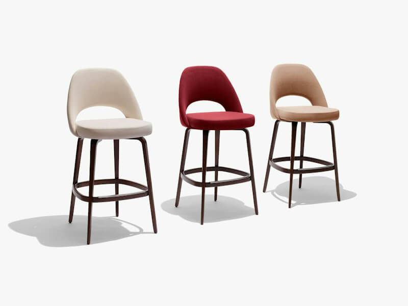 three Saarinen wooden legs Barstool ligned up on a white background