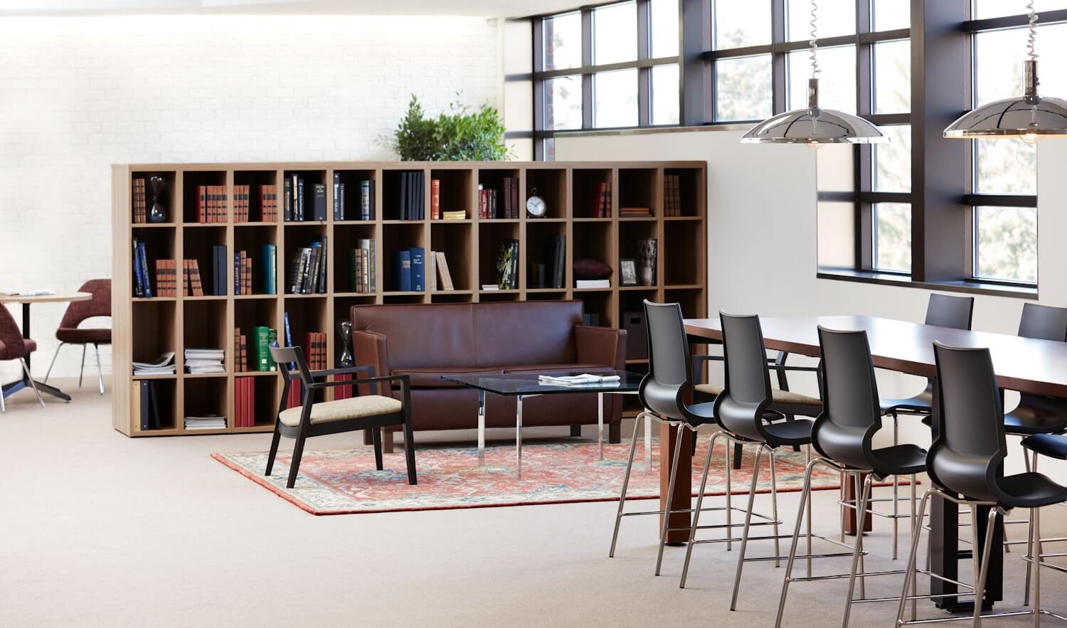 gigi barstool in a library wirh a leather sof ans a wooden chair