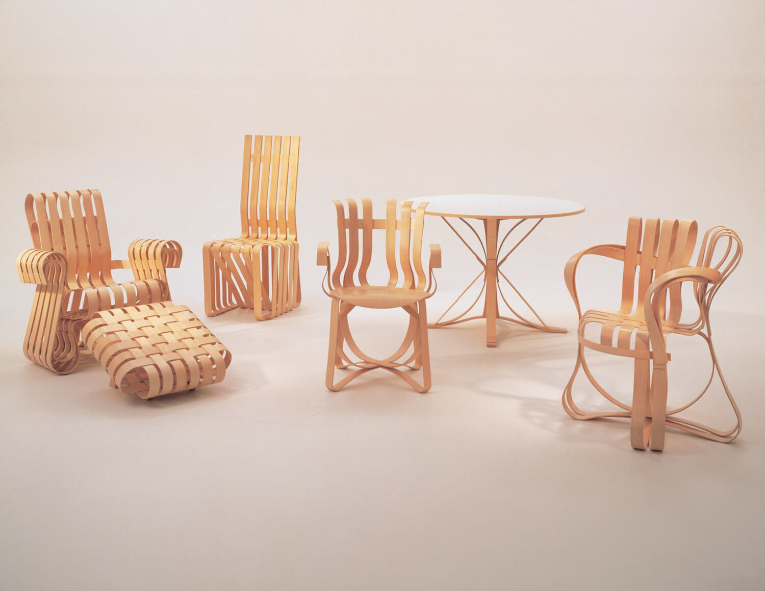 power play chair set of different models and table in a white room with dim yellow-pink light