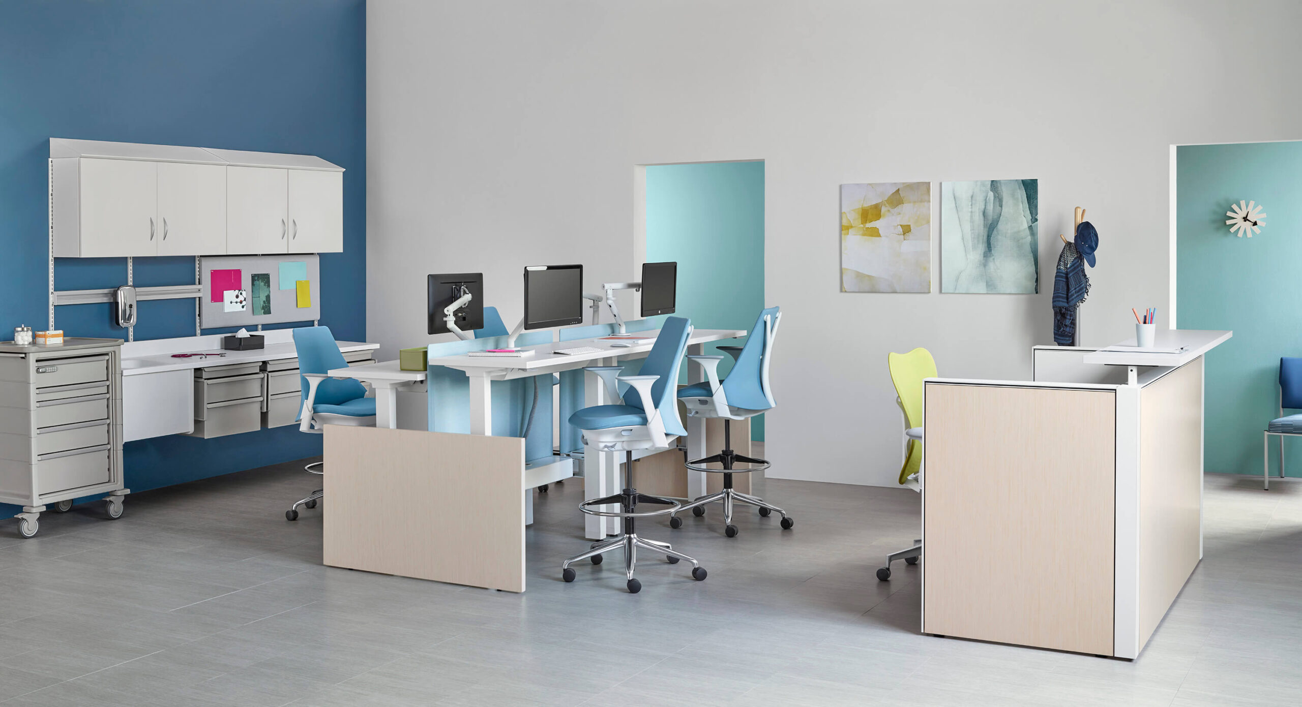Co-Struc System Medical Furniture featuring a sit to stand desks with light blue ergonomic sayl chairs