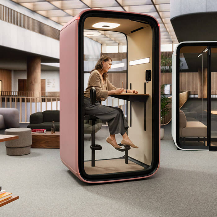 a person on a framery smart soundproof pod