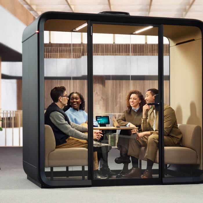 soundproof booth with four people inside at an australian workspace