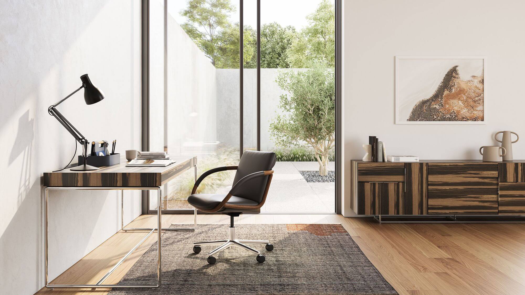 a homeoffice setting and wooden top desk next to a Full Loop Armchair with black leather upholstery and wooden frame