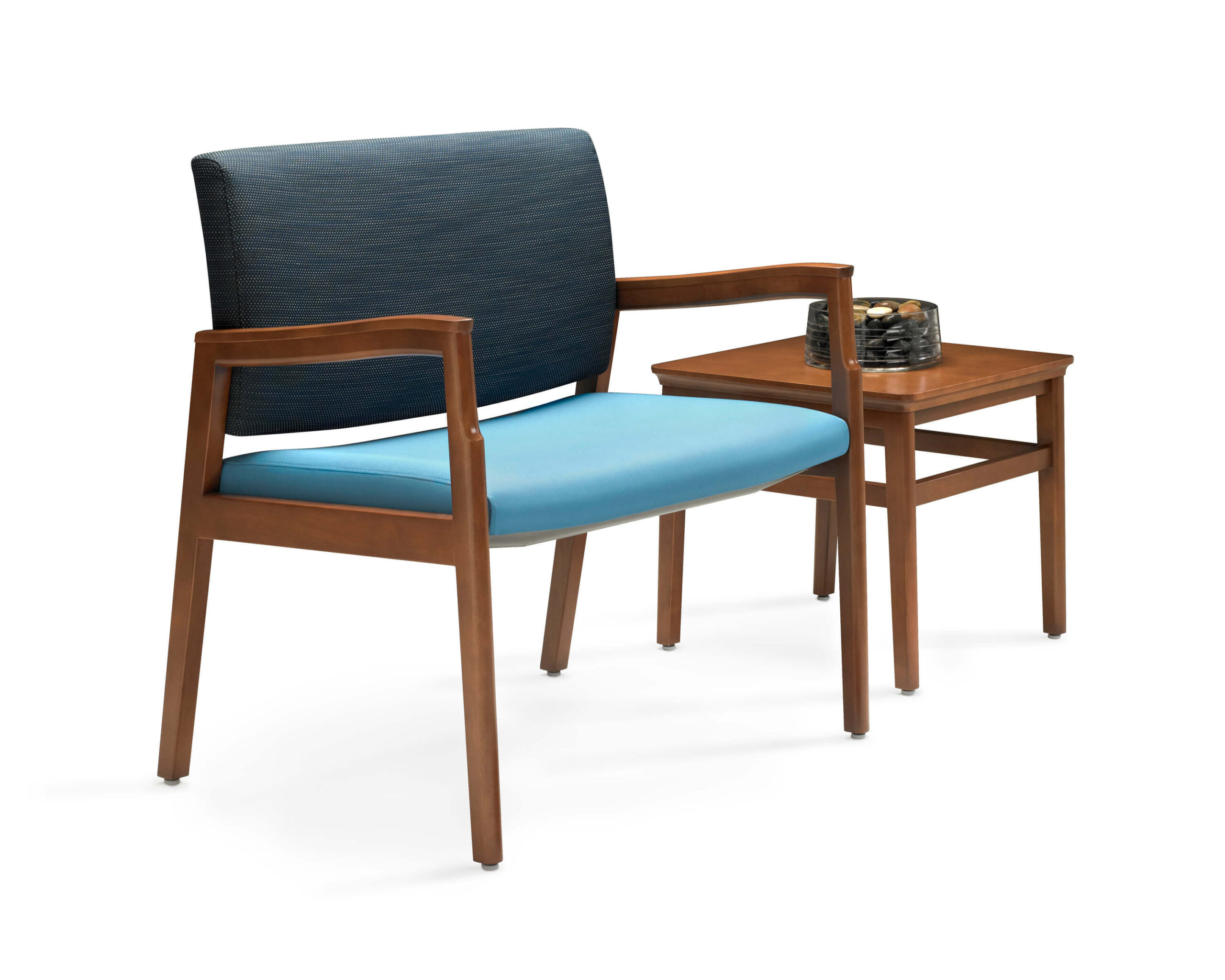 Monarch Plus Bariatric Patient Seating from the side with brown wood and blue seat and side table in a wbite room