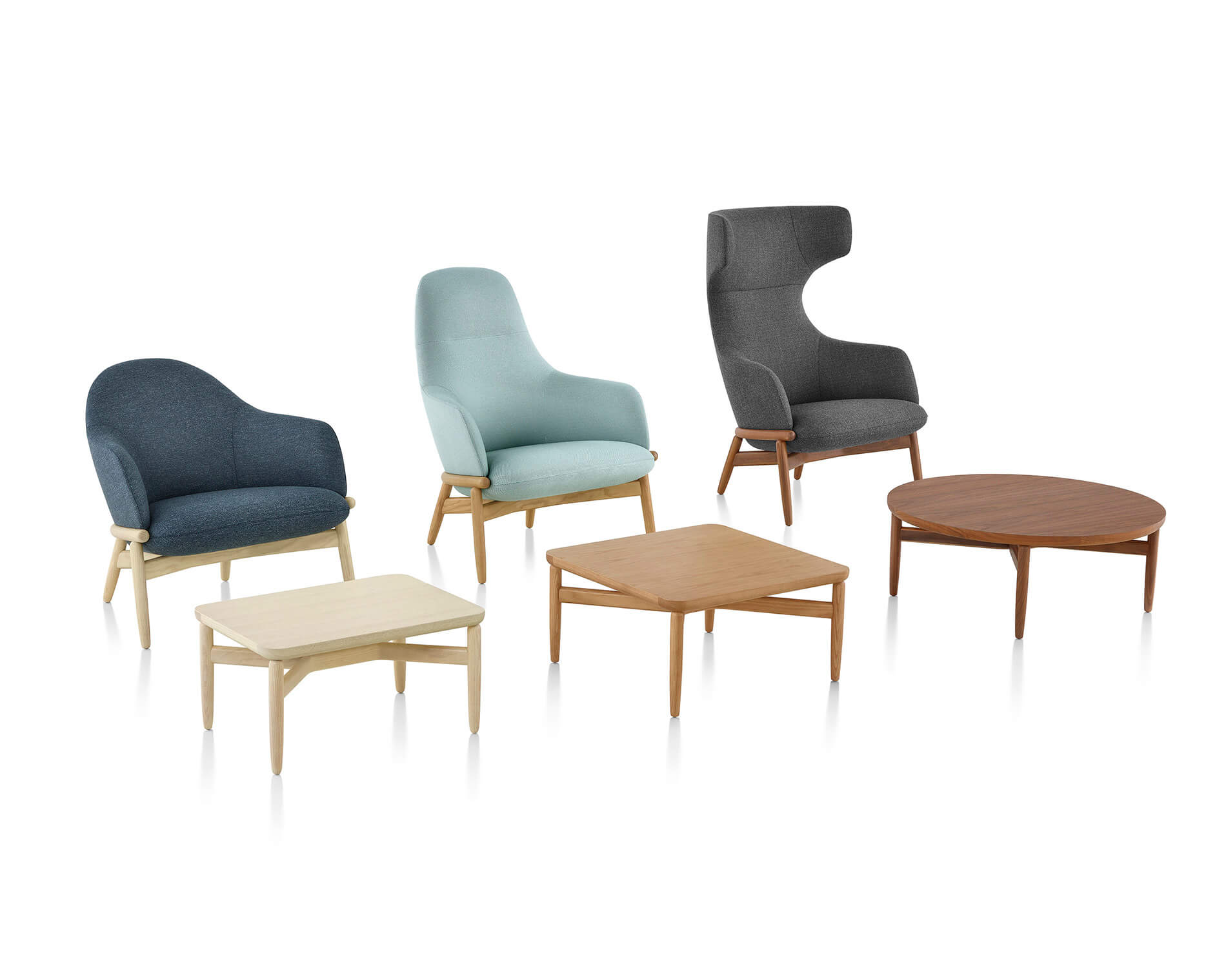 the side angle of three Reframe Lounge Chairs in diferent sizes, low back, midd back and high back with wooden bases in a white room with three coffee tables in front of each chair