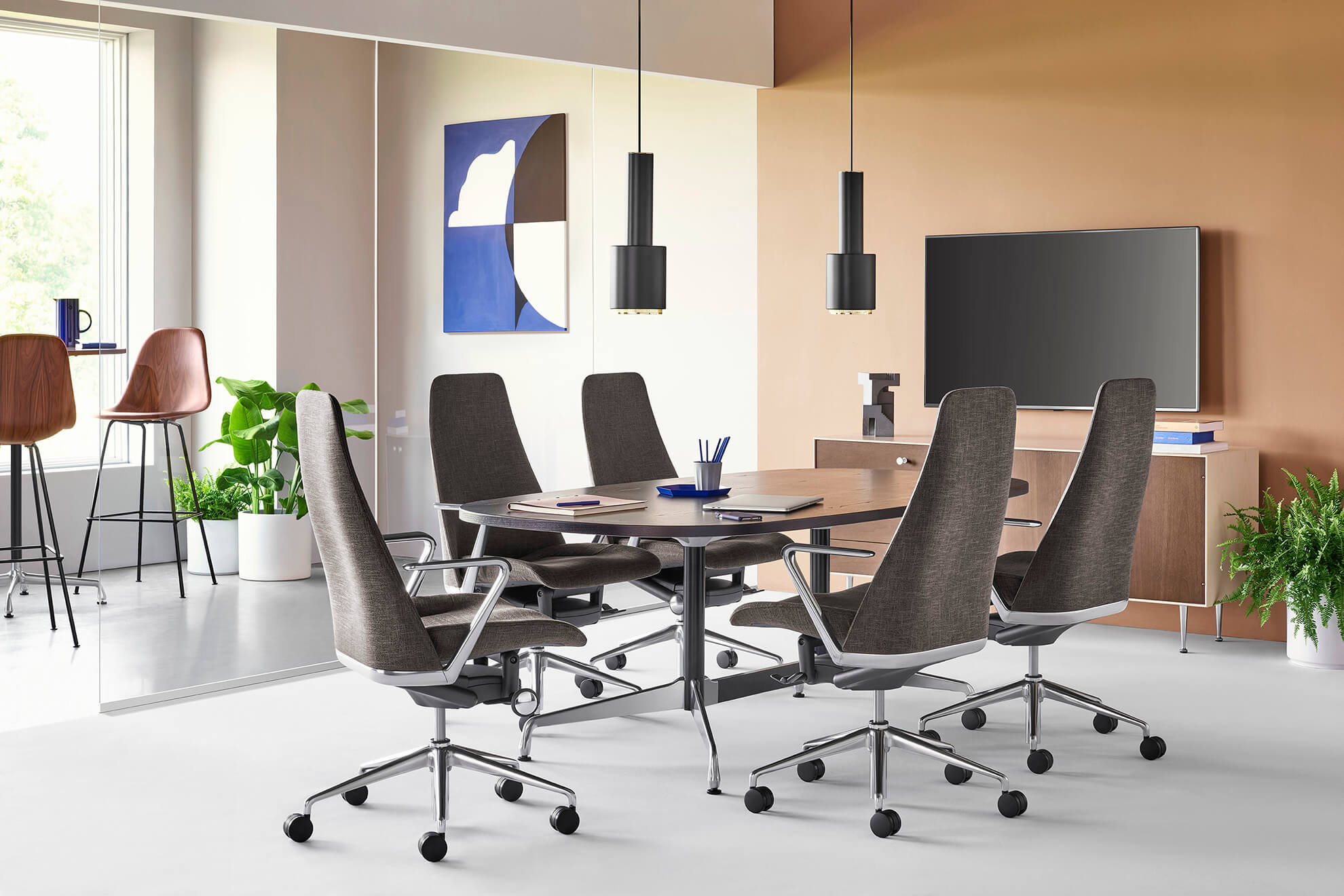 Five Taper Executive Chairs in gray marle colour and polished aluminium frame with swivel base and castor wheels. in a modern meeting room with a storage cabinet behind next to a glass wall