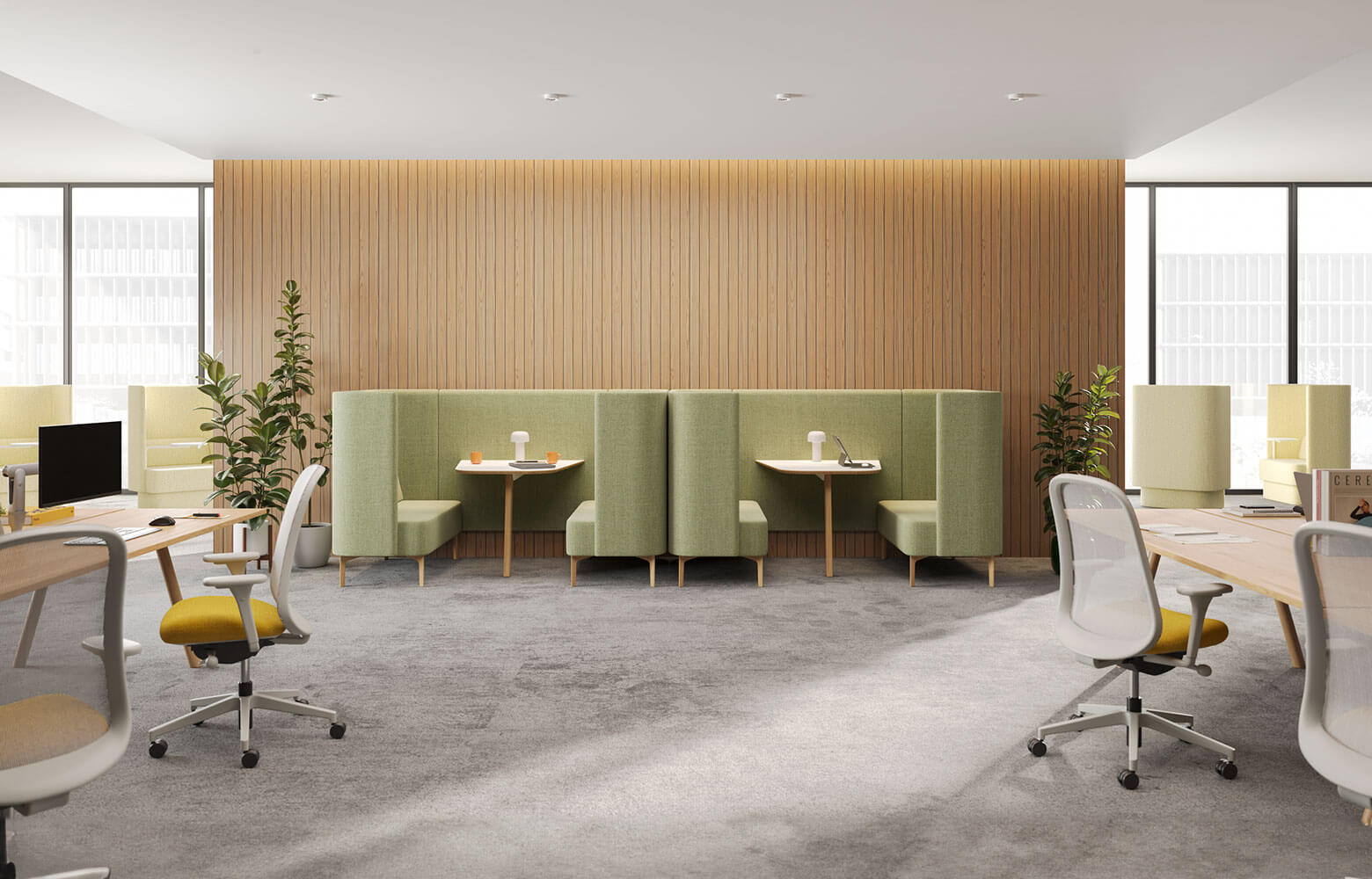 an agile modern office setting ready for Activity-Based Work, featuring lounge booths in the background and workstations on the left and right sides.