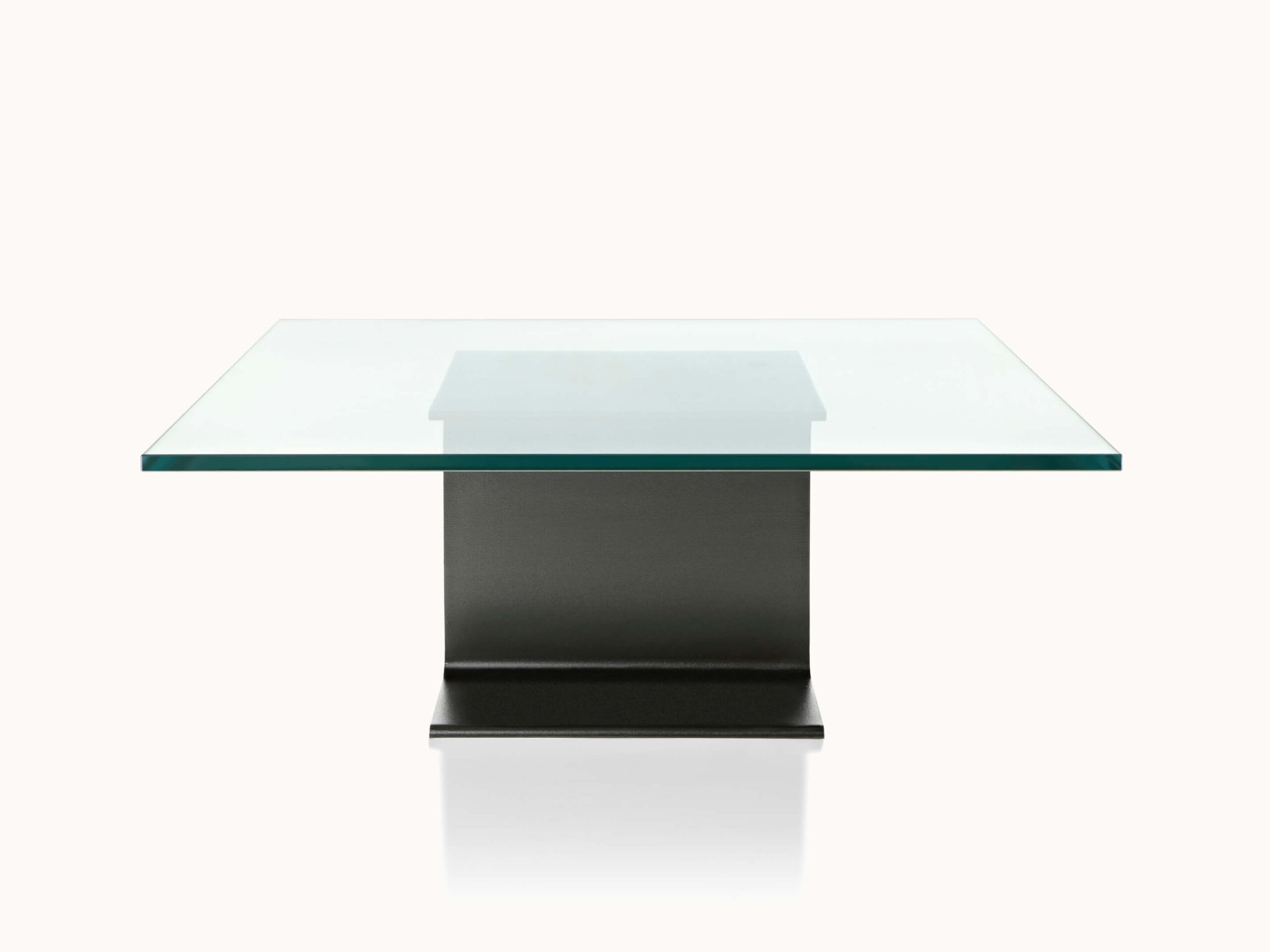 the left side of a glasstop I Beam Side Table in a white room