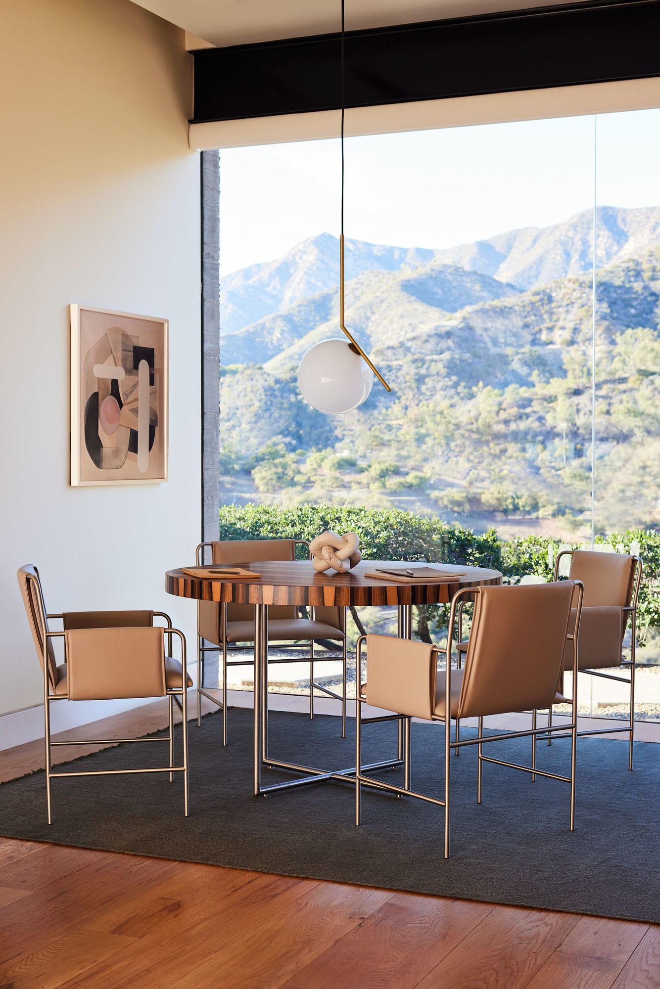 a modern meeting room next to a big windows featuring four envelope side chairs with cahqui leather in a modern paint in the wall