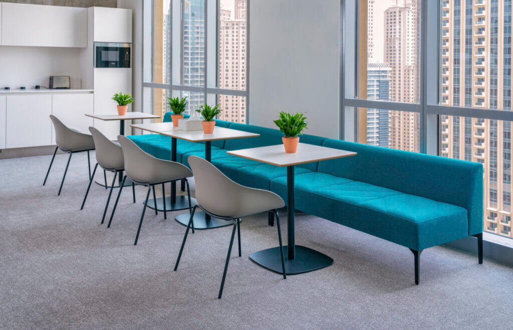 a modern shared commercial space featuring a line of Hatch Modular Sofas next to a big windows.