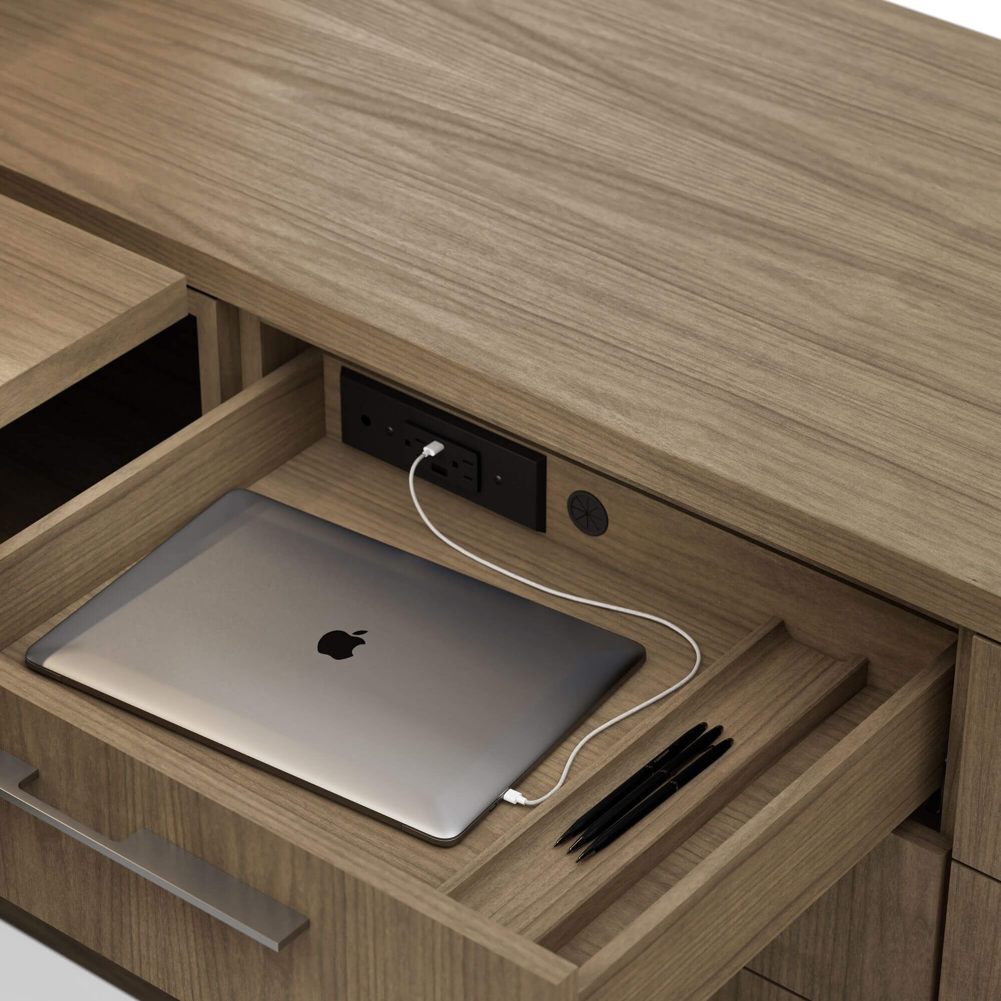 a close-up detail of a walnut wood geiger one private office unit drawer featuring power and usb conections and a charging laptop
