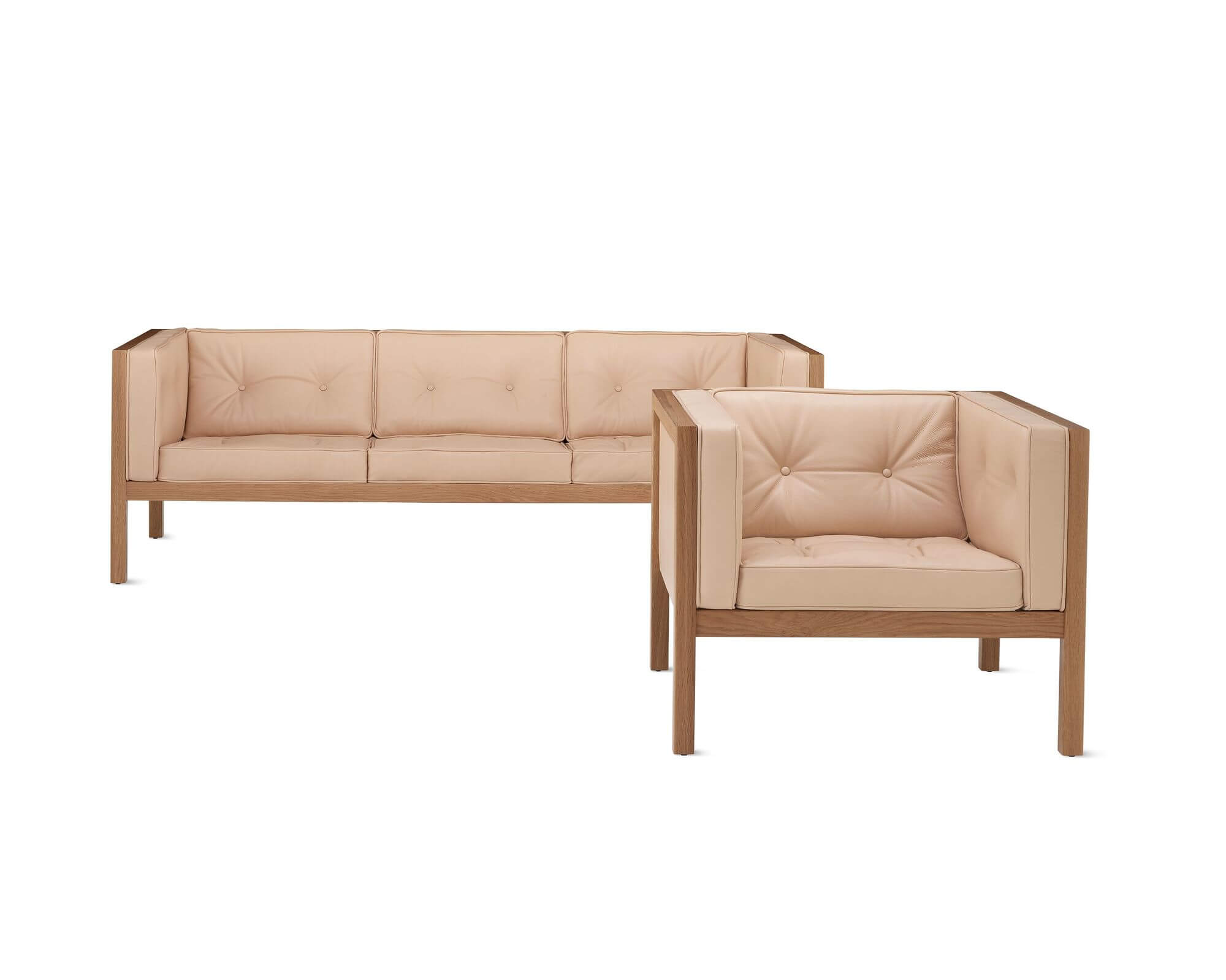 the front left side of a Nelson Cube Lounge Armchair and sofa in a white room