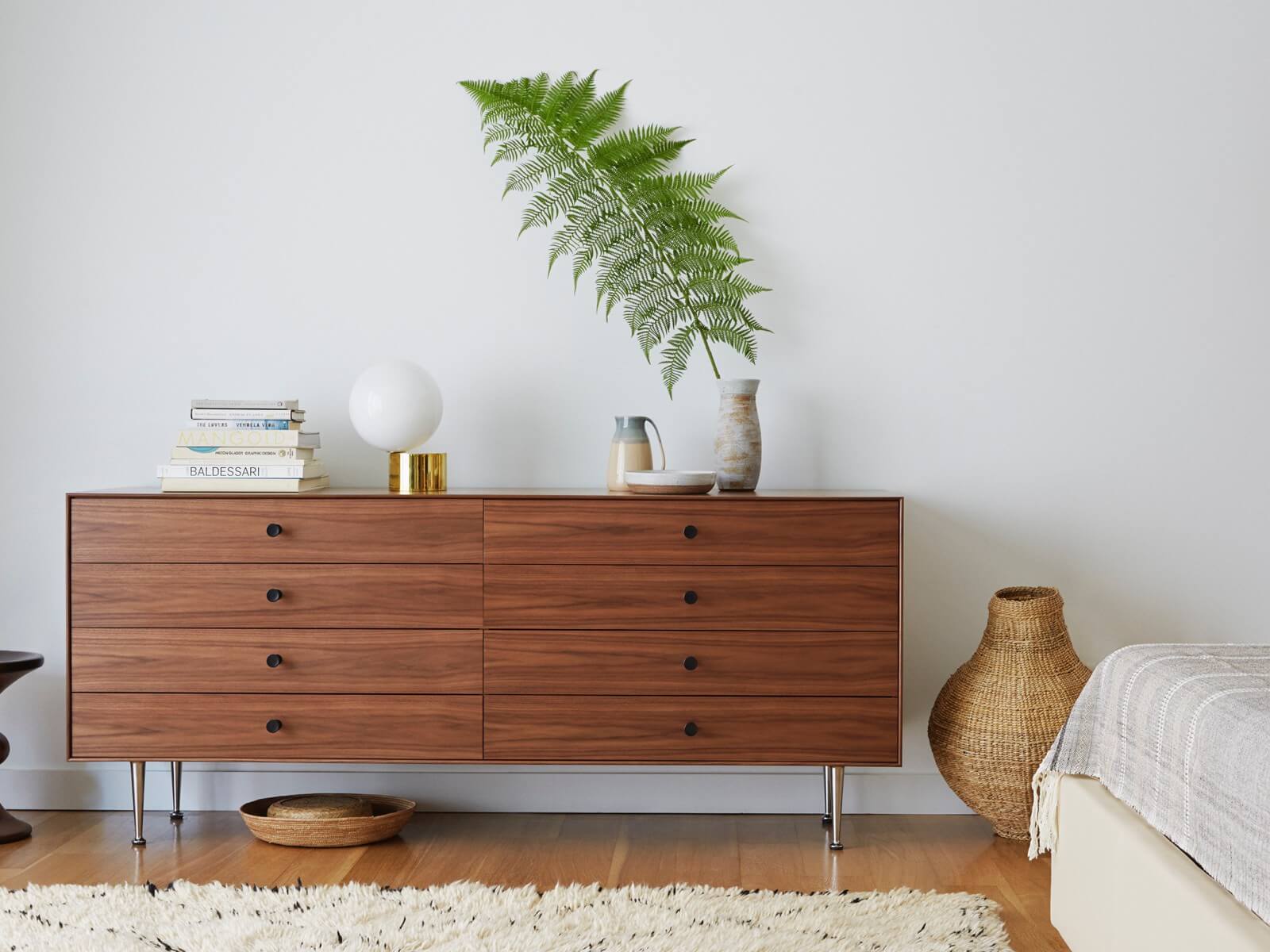 a Nelson Thin Edge Storage Buffet in ammodern room with books and a plant on top