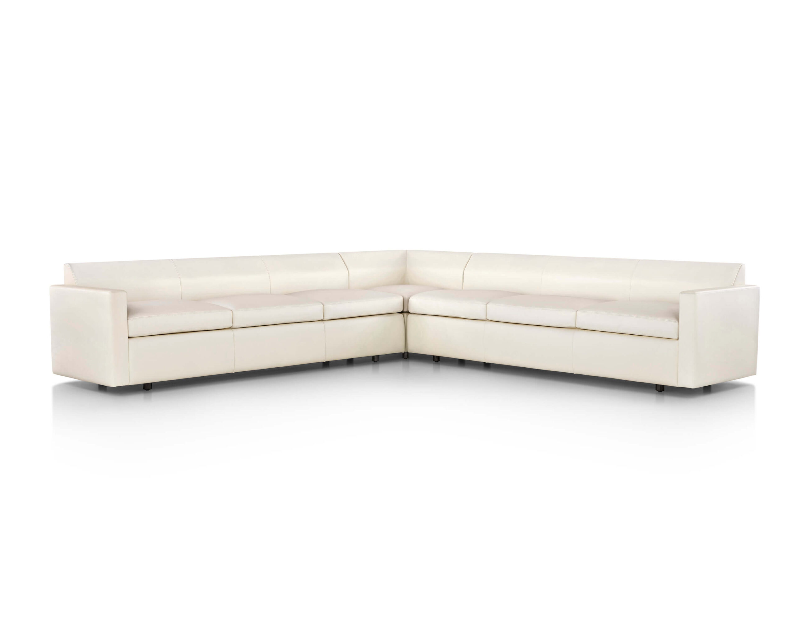 a cream L shapped Bevel Modular Sofa Group in a white room