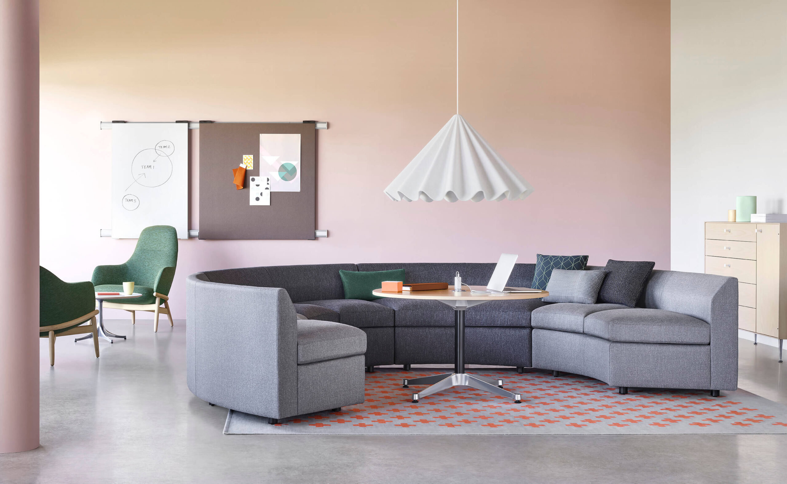 a gray U shapped Bevel Modular Sofa Group in a modern commercial area with a side table in the middle and two lounge chairs in the left side