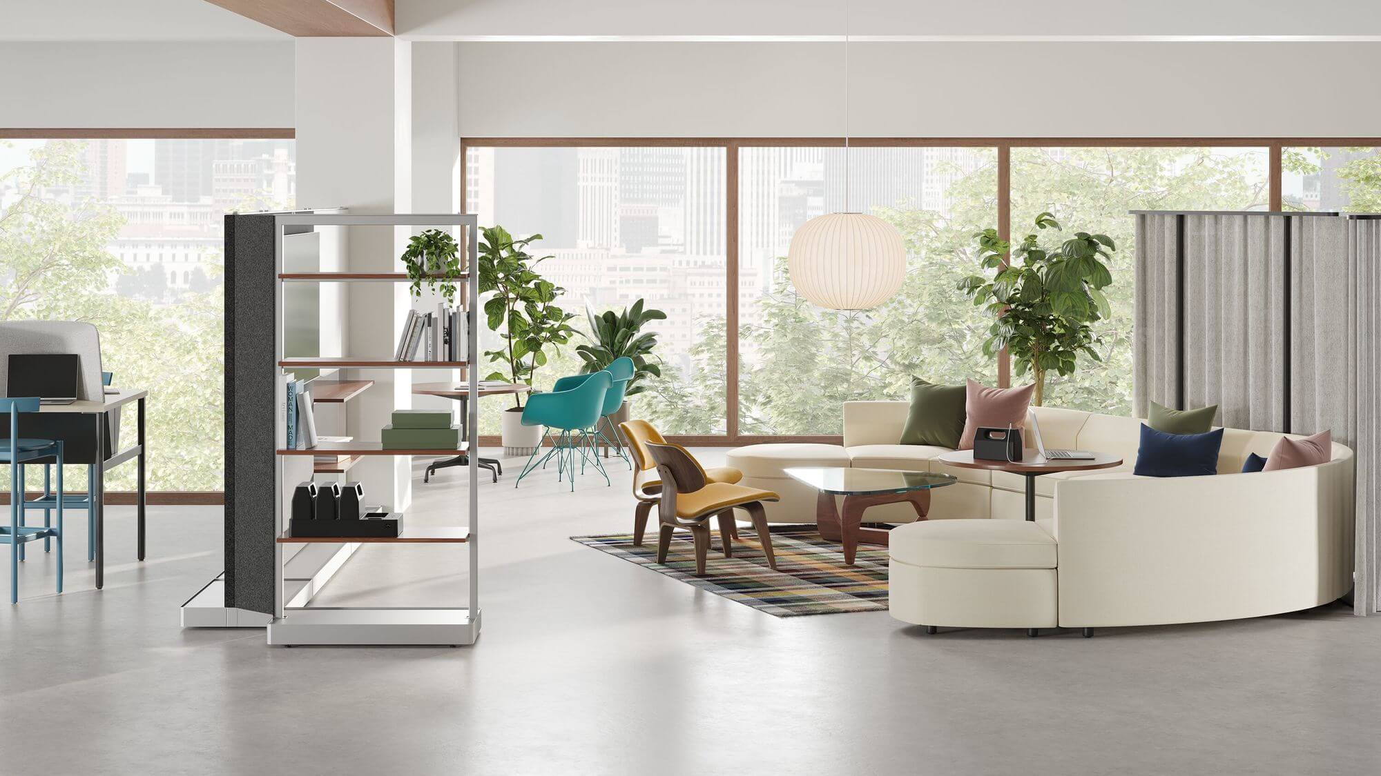 a lounge area in an office featuring a tv rach and book shelf in the left side and a person sitting in a Striad Lounge Sofa in the right side and a big window with a side chair in the background