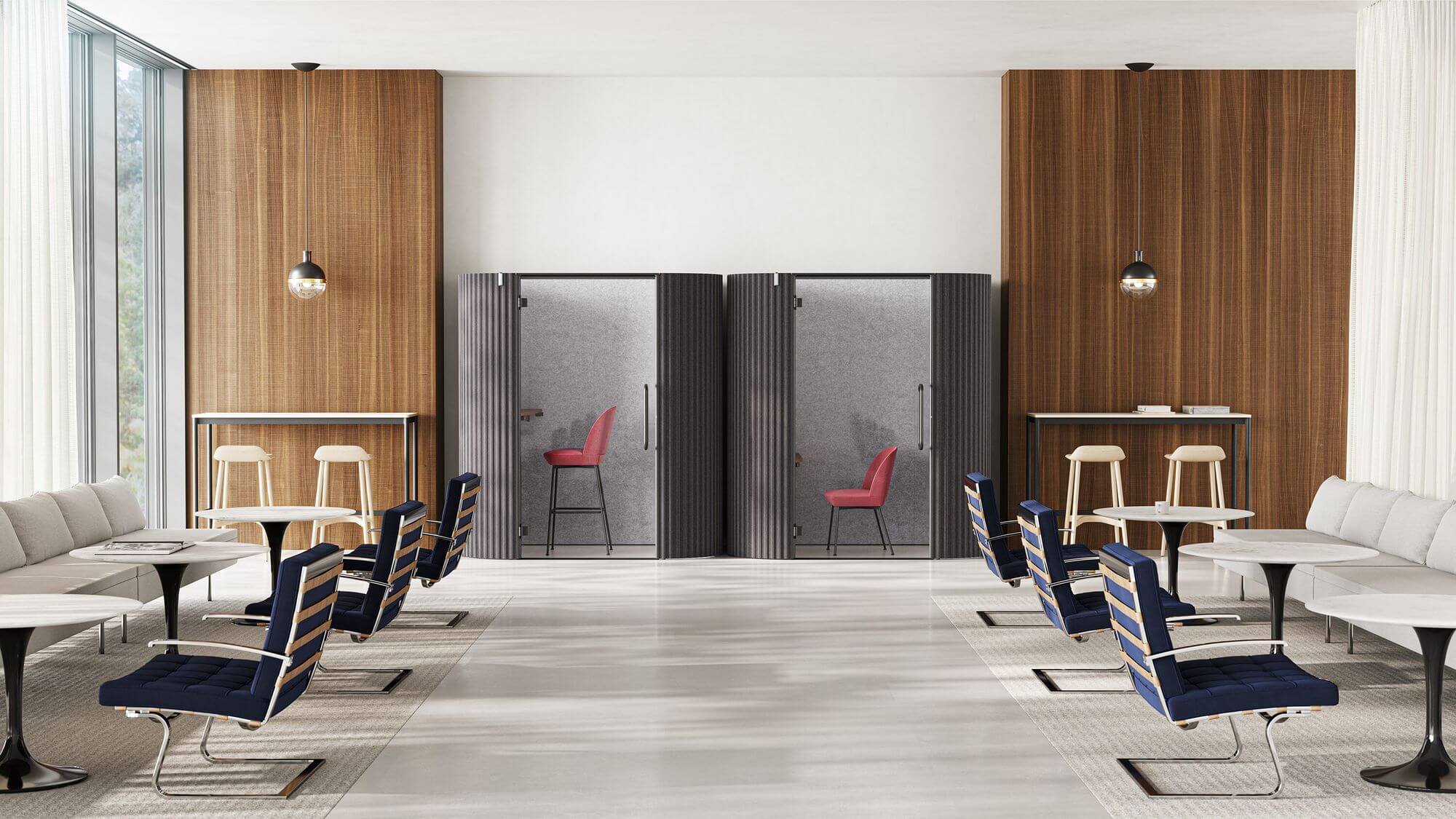 a modern commercial space with side tables and two Bolster Sofa Group on the sides with two soundproof pods in the background