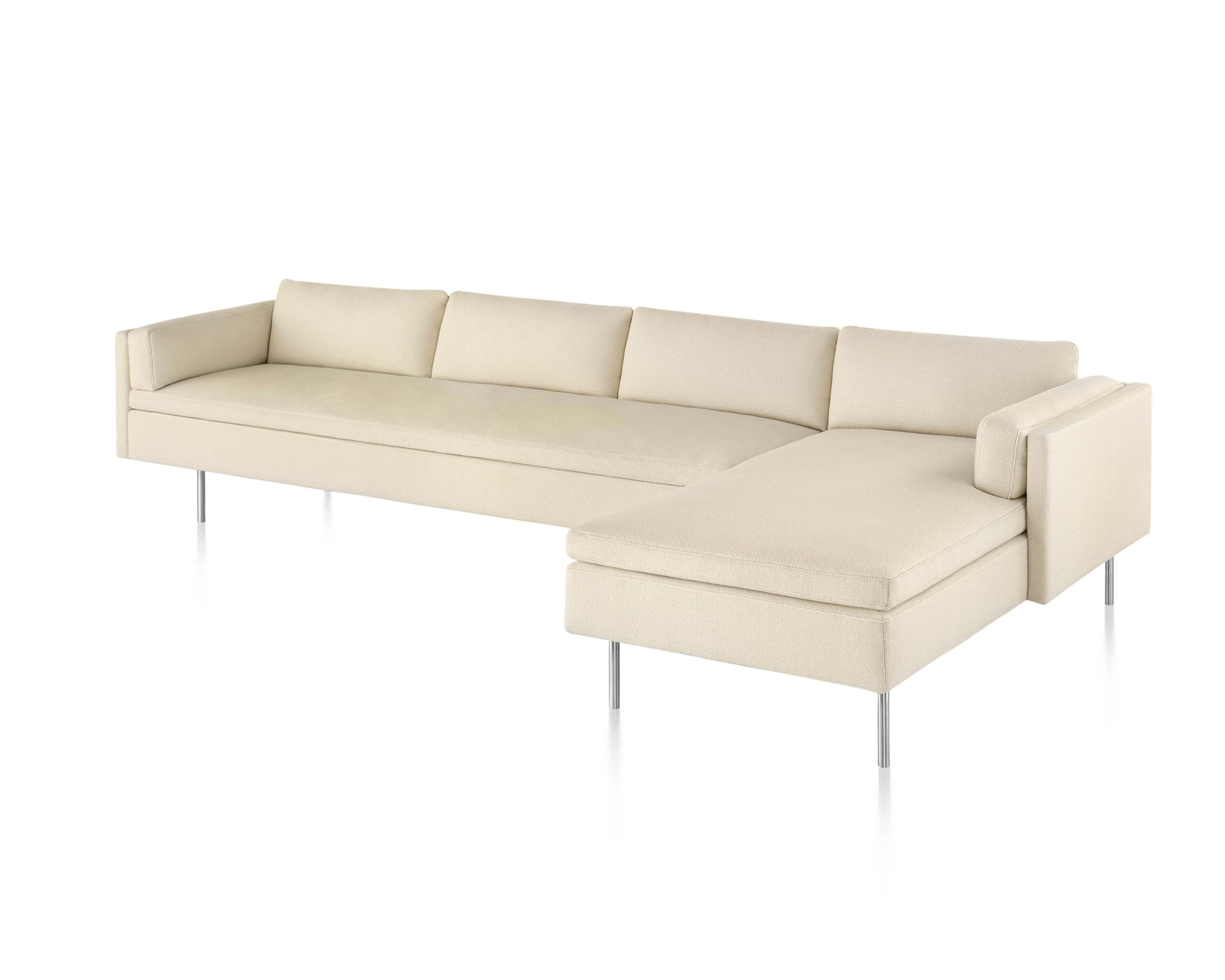 the front side angle of an L shapped cream Bolster Sofa Group in a white room
