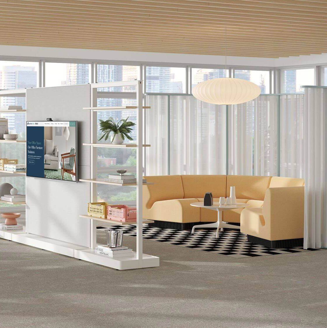 a U shaped Chadwick Modular Sofa in light yellow colour in the right side and a small meeting room in th right side. with a TV mount in the middle