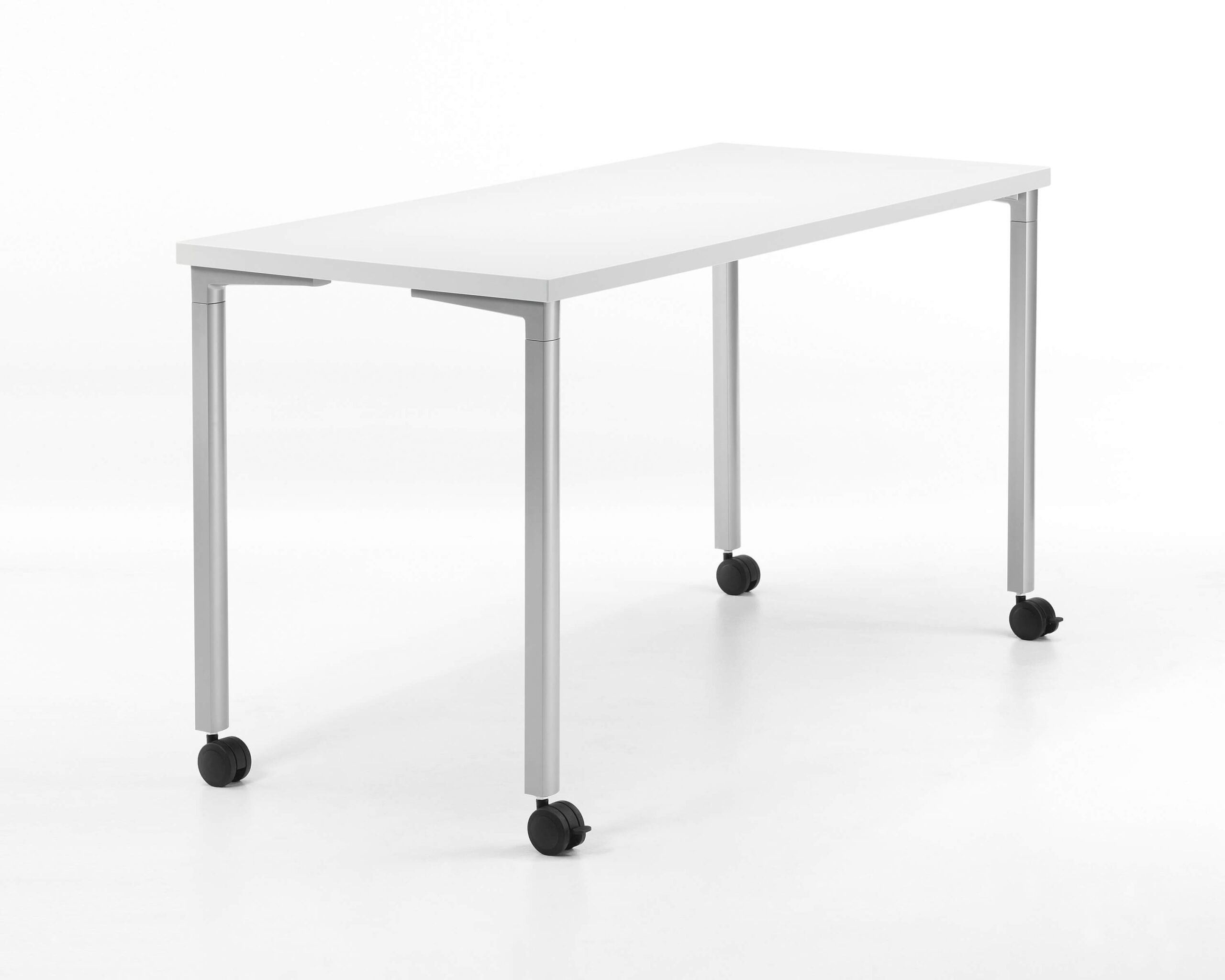 a narrow white top Everywhere Multi-Purpose Table with white legs in a white room