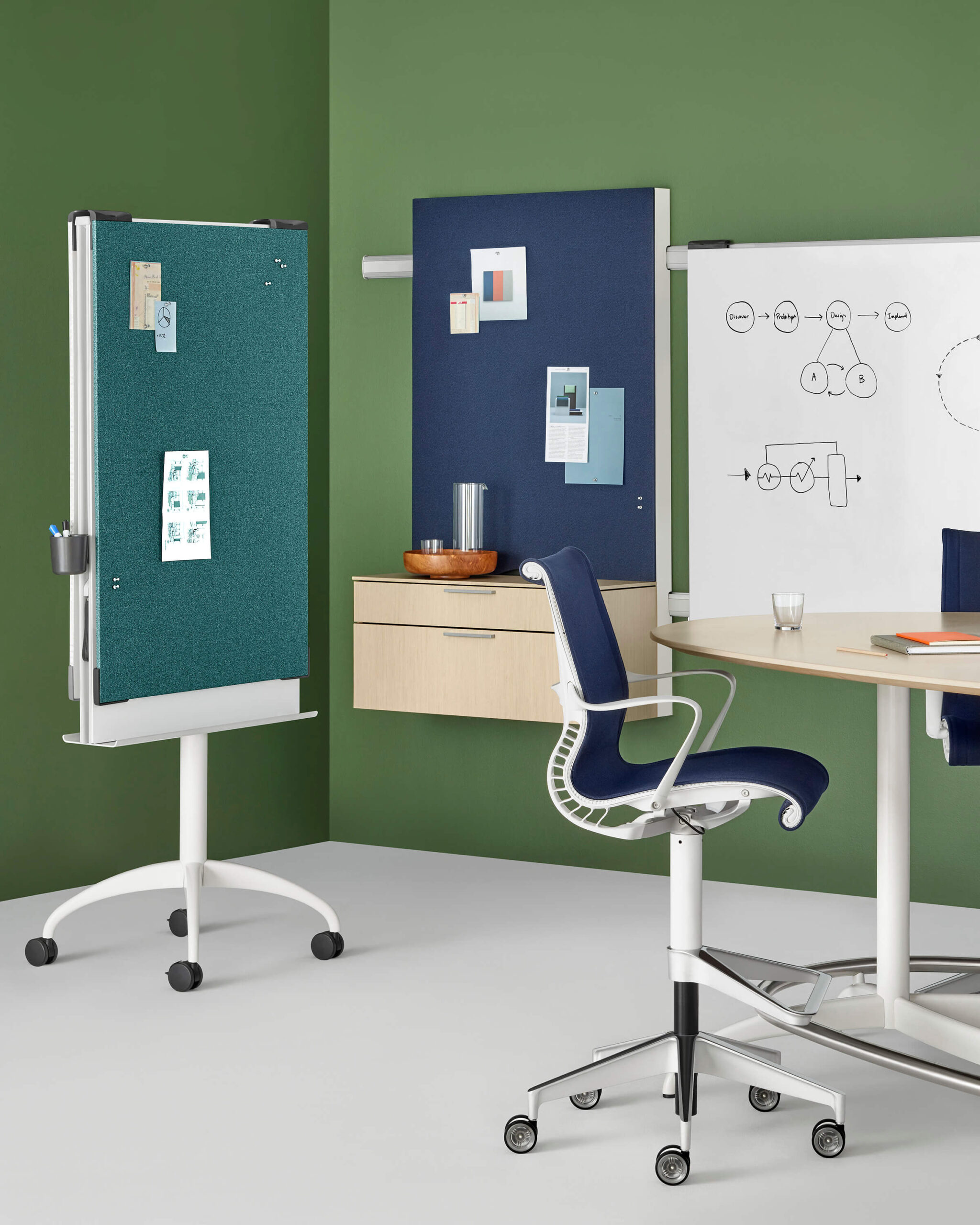 a movable screen of an Exclave Workshop Furniture next to a stool and high table