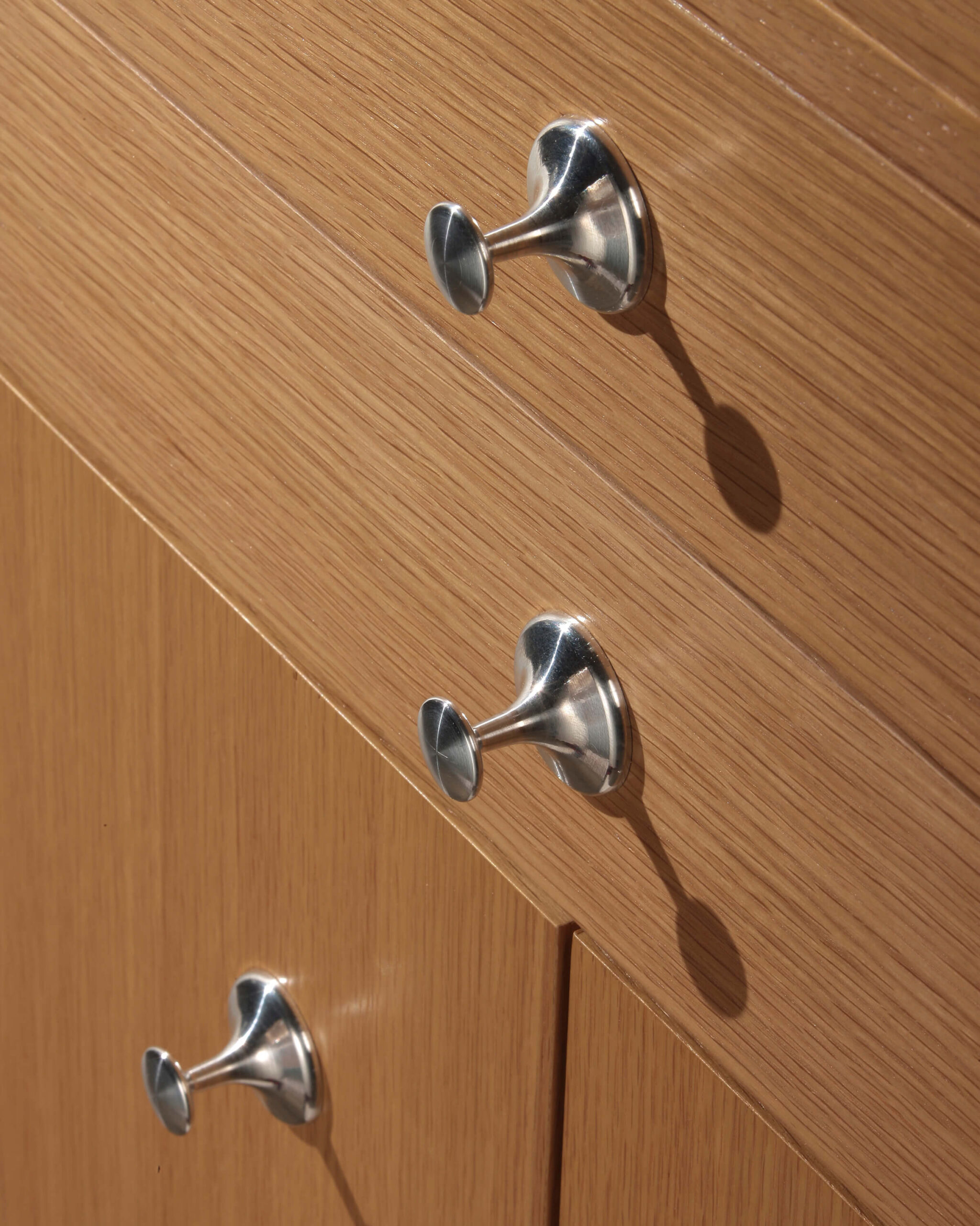 the close up image of the handler details of a walnut wodd Nelson Basic Storage Cabinet Series