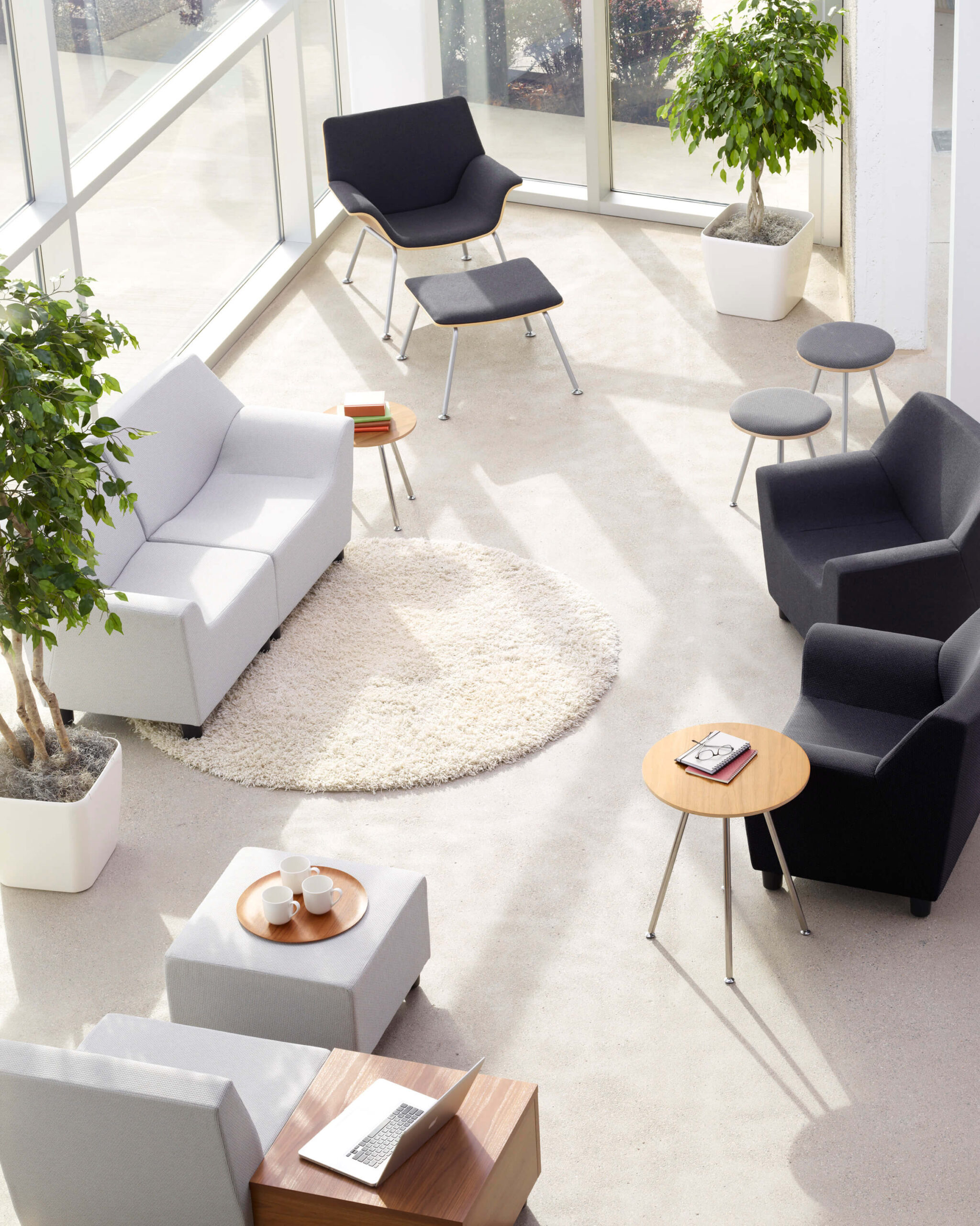 the top view of a reception area featuring modern lounge chaies and a Swoop Modular Lounge Sofa next to decoration plants