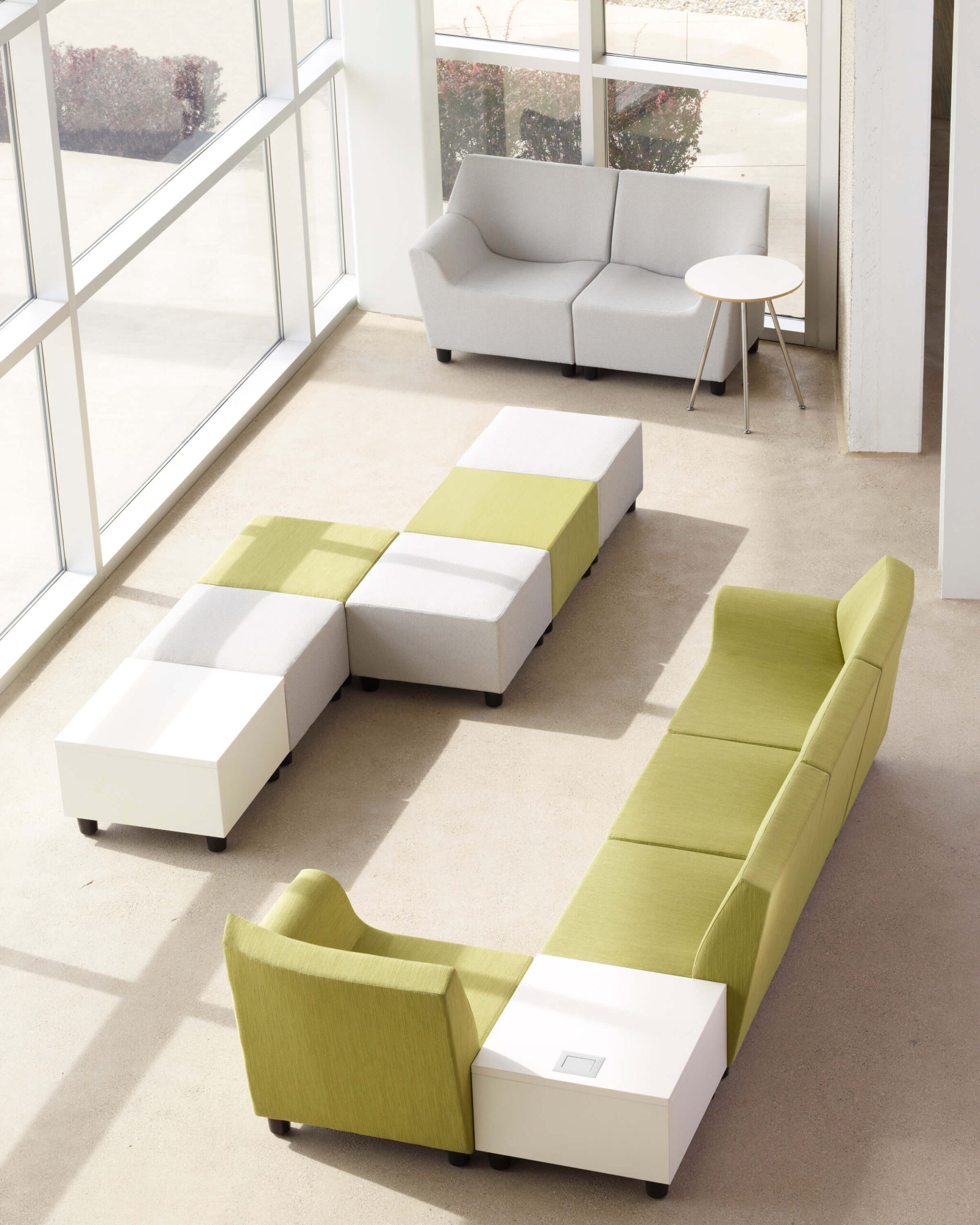 a modern commercial space featuring Swoop Modular Lounge Sofas next to big wall windows