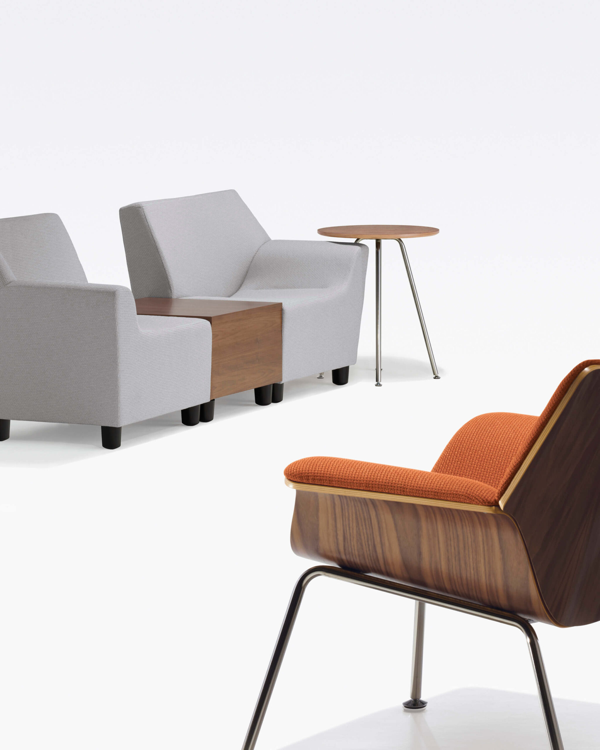two Swoop Modular Lounge Sofas with an inbuilt side table in the middle and a lounge chair in the right corner