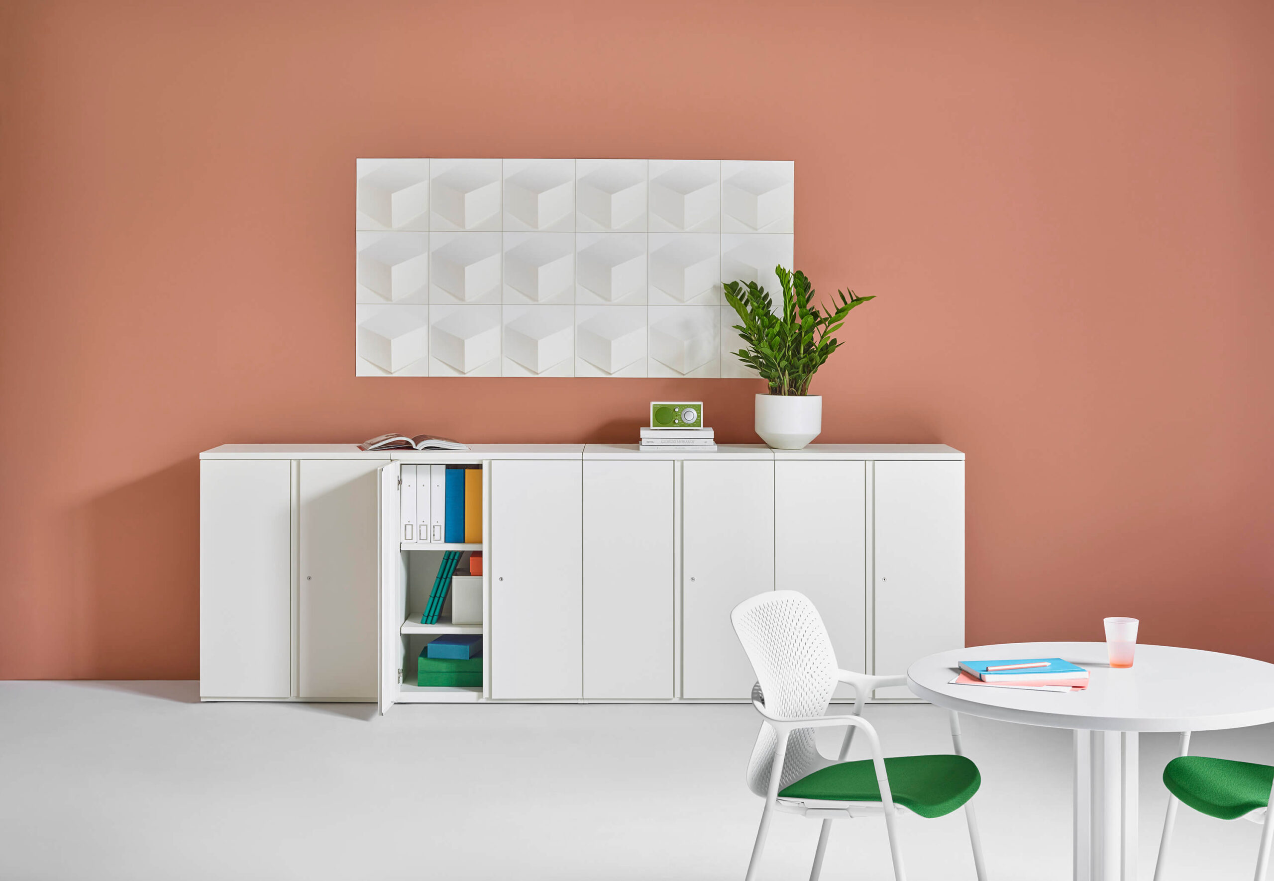 a modern colourful room with a white Tu Metal Storage Cabinets & Lockers and a white side table and side chairs around