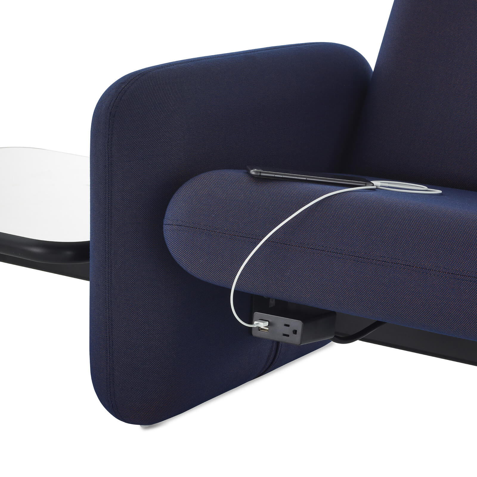 the side arm rest detail of a Wilkes Modular Sofa Group with a charging port in a white room
