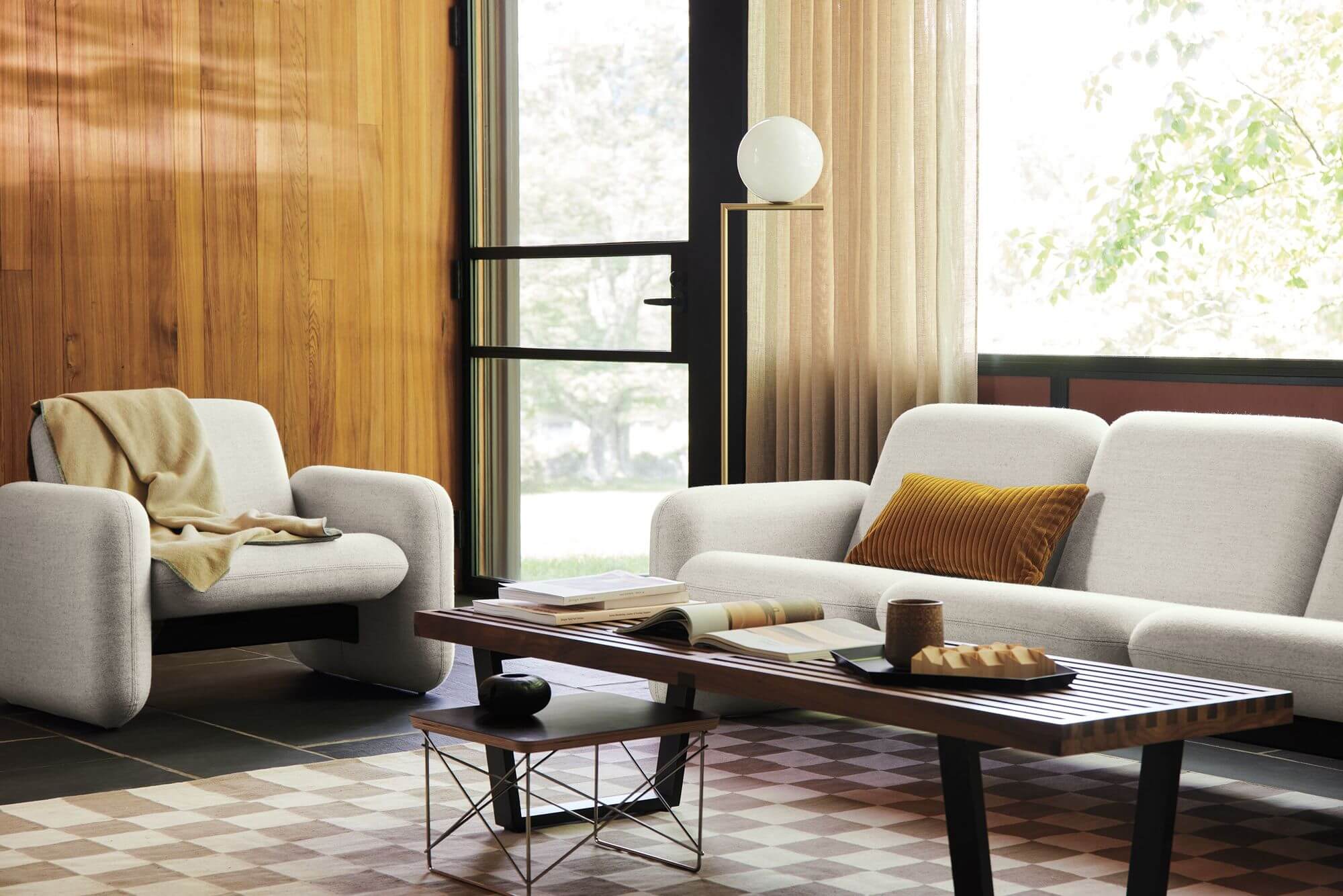 a stylish commercial space with a Wilkes Modular Sofa Group and a Wilkes lounge chair with a bench coffee table in the middle