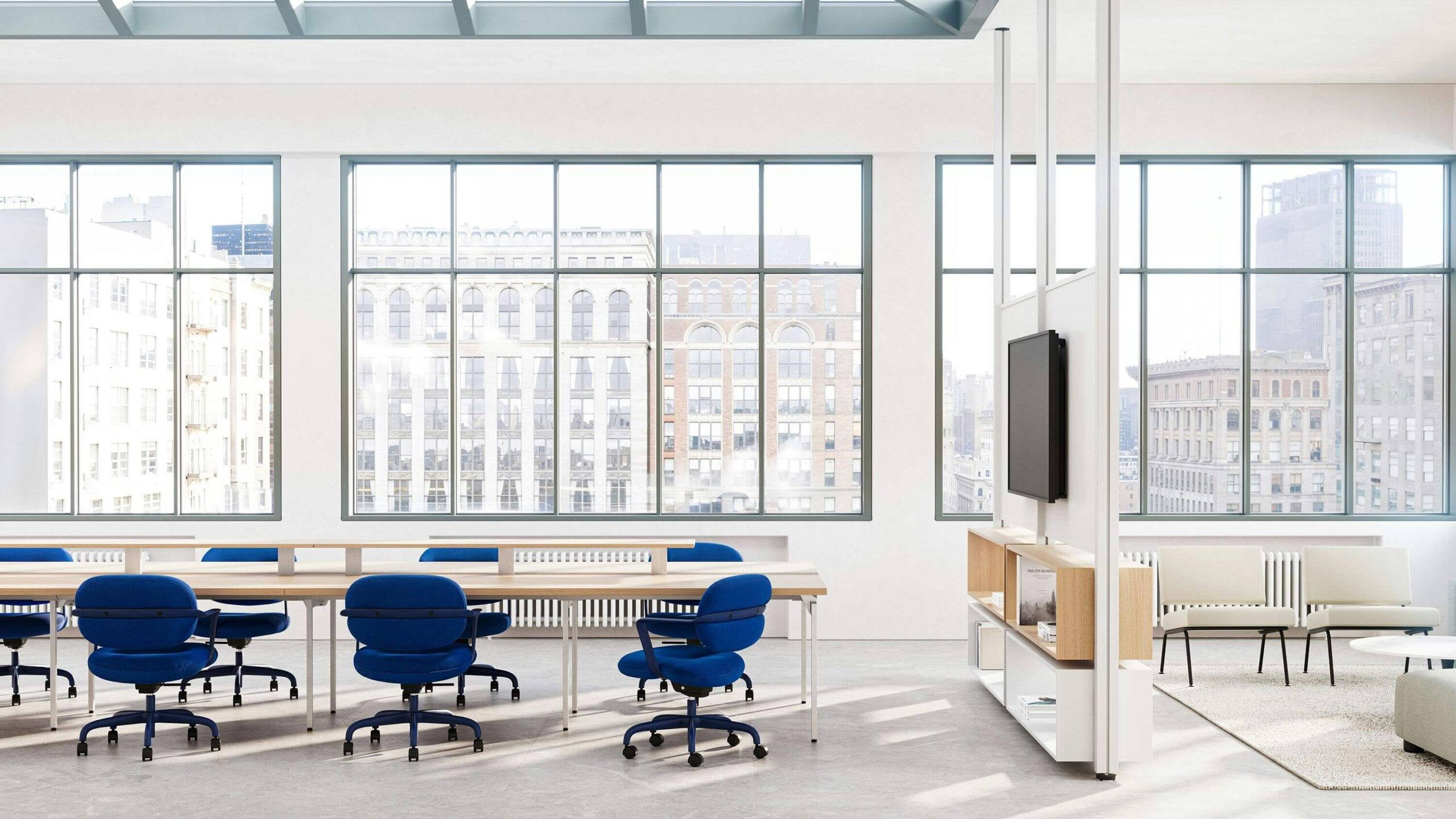 morrison hannah chairs in blue colour and a long meeting table and a tv mount in the right side with a big window in the background.