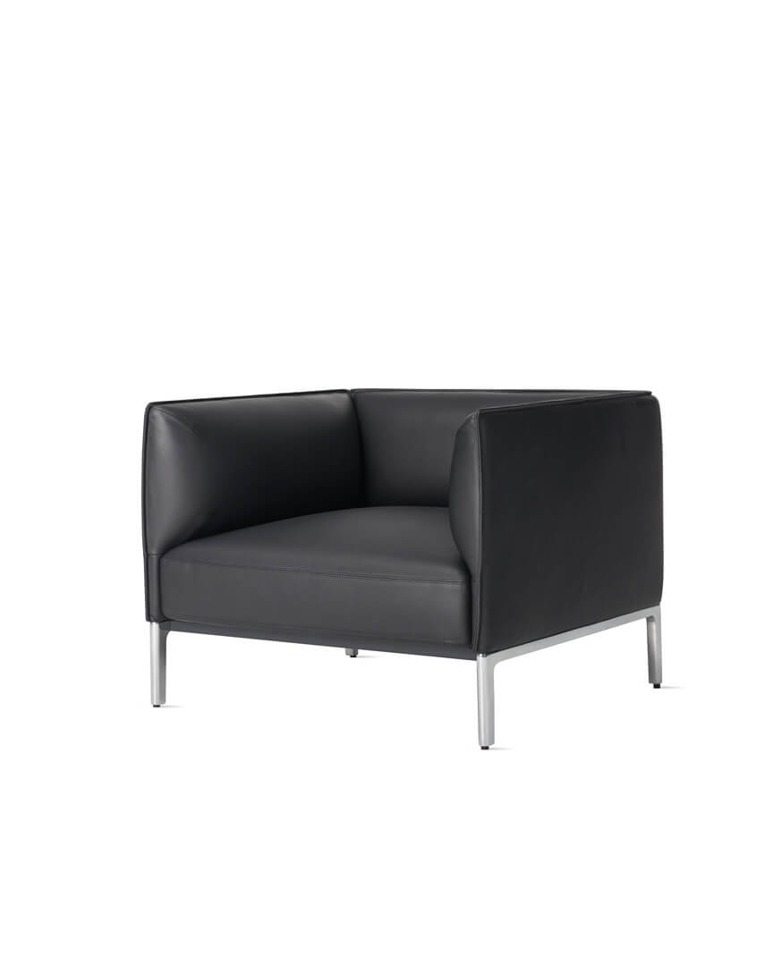 the side angle of a single seat black leather mimo sofa by naughtone in a white room