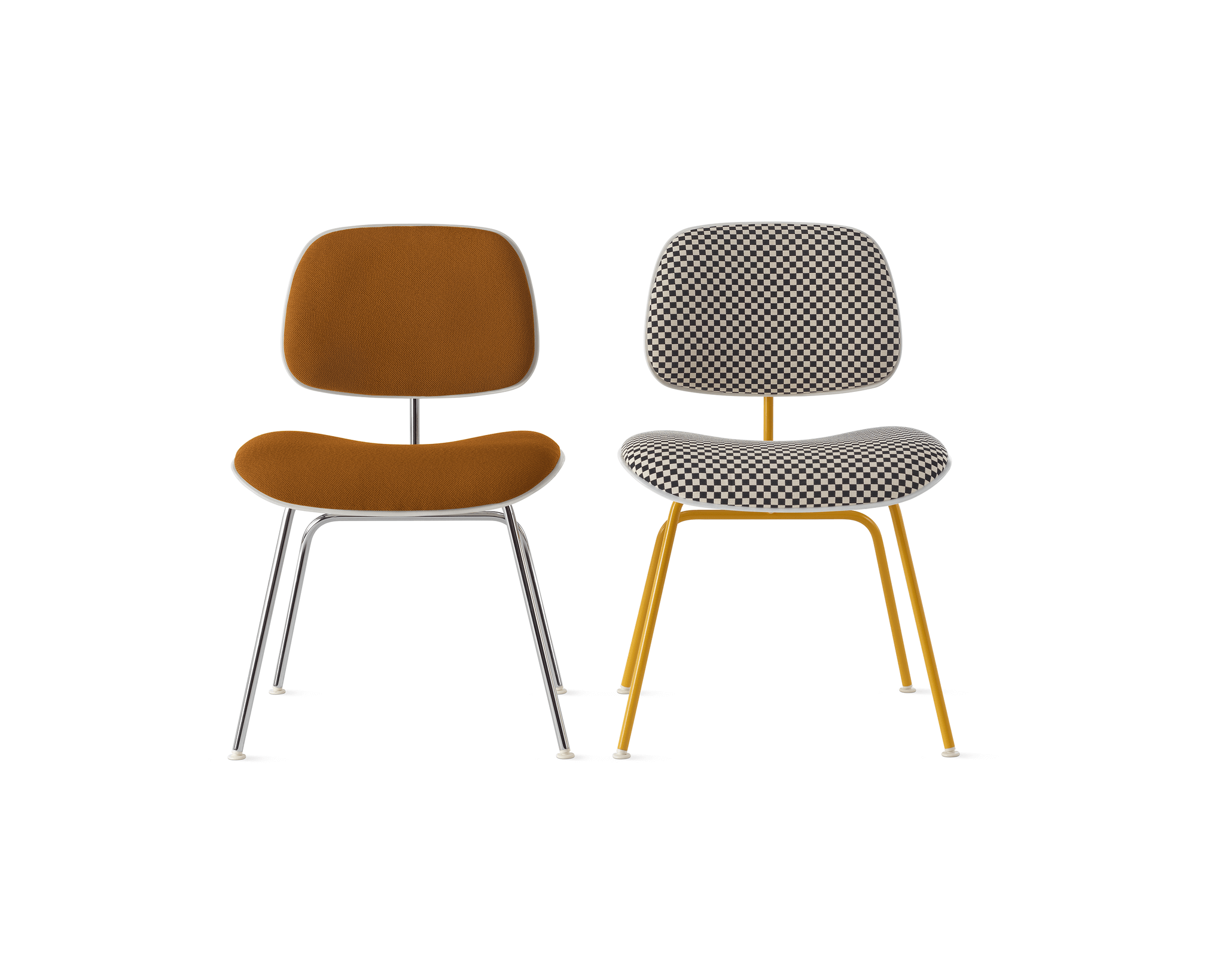 two eames molded plastic dining chairs in red and upholtered colour in a white room